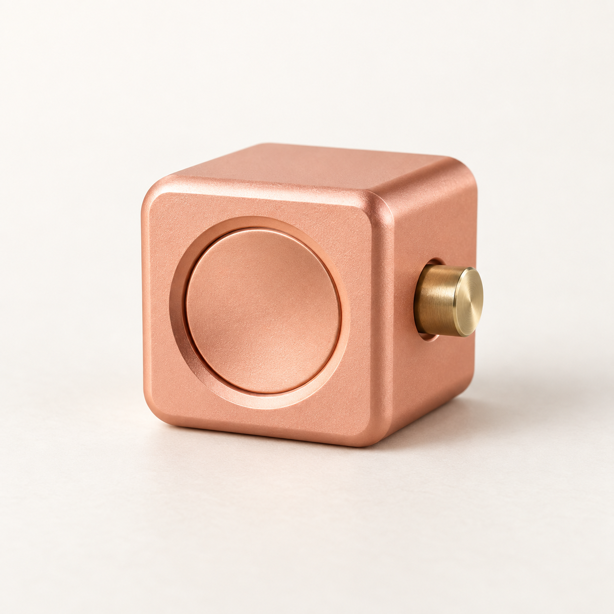 Peach modular metal widget with a circular center and a brass pin